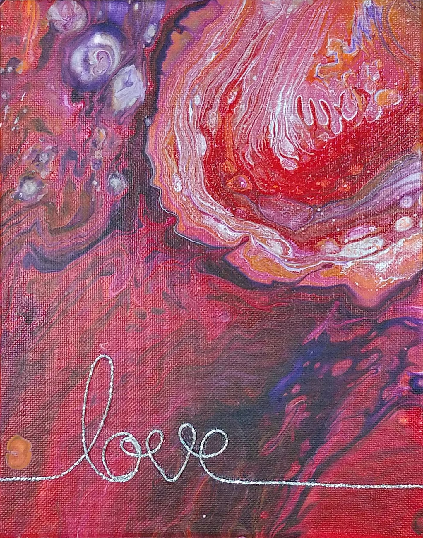 Abstract paint pour with flowing colors creating heart-like form